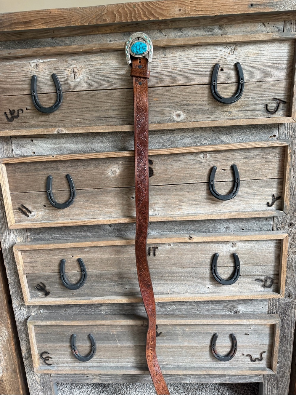 Western tooled belt with horseshoe buckle